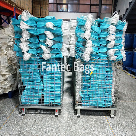 "Stacks of aqua blue kraft paper bags arranged in colorful racks."