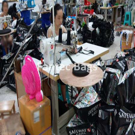 "Assembly line producing non woven bags with automated sewing and stitching equipment."