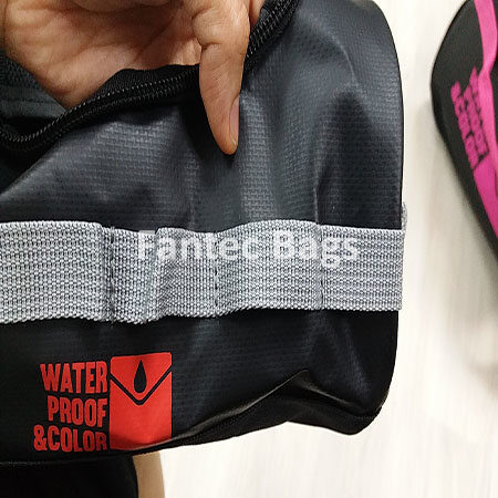 "Close up inspection of PVC bag strap connection showing waterproof stitching and durable material."