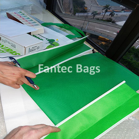 "Customer inspection process checking non woven bag lamination quality."