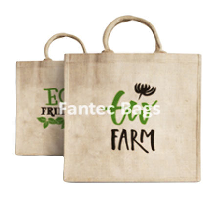 "Reusable eco jute shopping bag with short handles and printed green design, ideal for sustainable packaging."