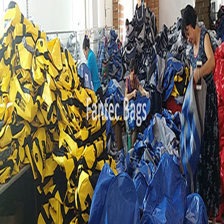 "Inspecting bag seams for leaks or gaps during quality control process."