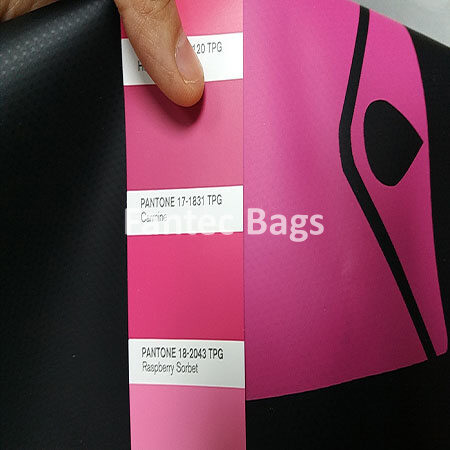"Pantone swatches compared against pink PVC material to confirm shade accuracy."