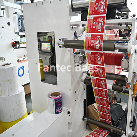 "Industrial label printing machine producing branded rolls with precision rollers and control panels."