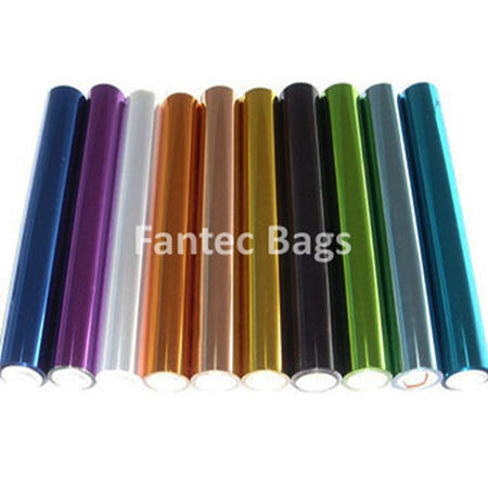 Ten rolls of metallic colored foil in purple, silver, copper, gold, black, green, and blue tones arranged side by side