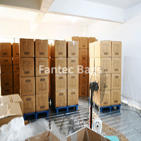 "Warehouse with ventilated storage stacks of boxed packaging materials prepared for shipment."
