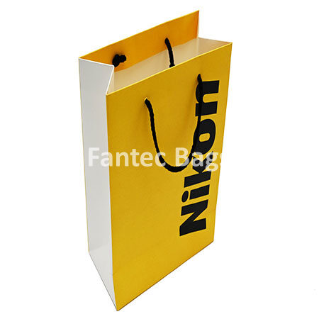 "Eco-friendly white kraft paper shopping bag photographed face-on with rope handles."
