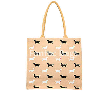 Tote bag with repeating black and white dog silhouettes in horizontal rows