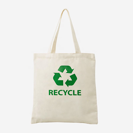 "Canvas tote tag displaying bold green recycle emblem."
