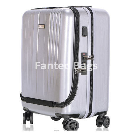 Silver hard shell suitcase with vertical ridges, four wheels, and built in lock