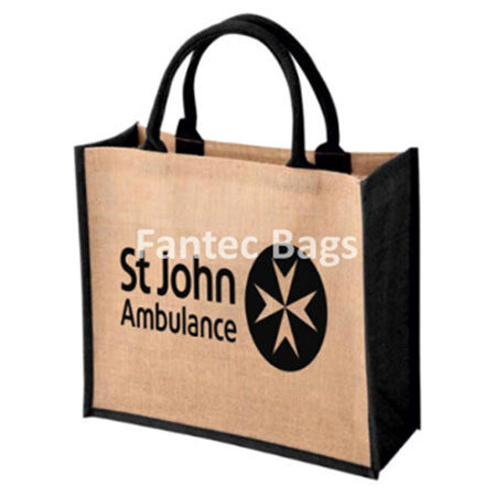 Tan tote bag with black handles and St John Ambulance logo print